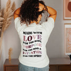 Person wearing a white t-shirt with motivational text on the back.